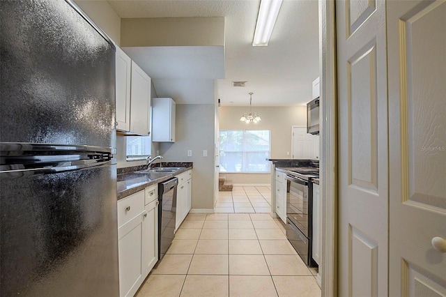 kitchen with sink, decorative light fixtures, white cabinetry, light tile patterned floors, and black appliances