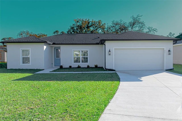 ranch-style house featuring a garage and a front lawn