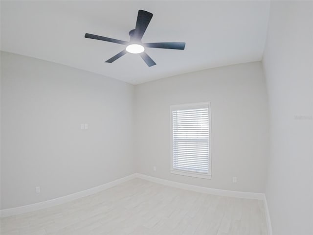 empty room with ceiling fan and light hardwood / wood-style flooring