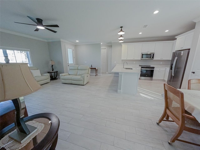 living room featuring ceiling fan, sink, and crown molding