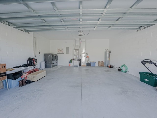 garage with washer and dryer, electric panel, and a garage door opener