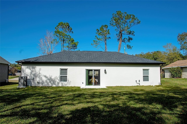 rear view of house with a yard