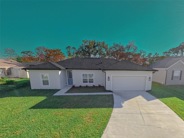 view of front of property featuring a front yard and a garage