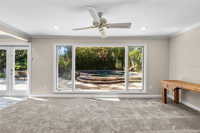 empty room featuring plenty of natural light, french doors, and ornamental molding