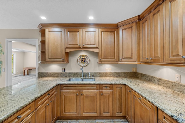 kitchen with light stone countertops and sink