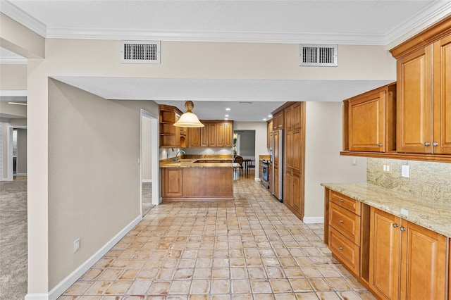 kitchen featuring backsplash, sink, light stone countertops, ornamental molding, and high quality fridge