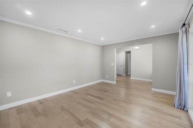 unfurnished room with light wood-type flooring and ornamental molding