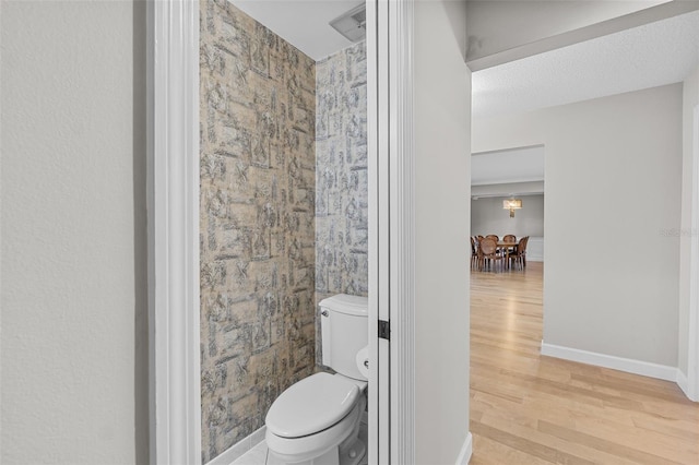 bathroom featuring hardwood / wood-style floors and toilet