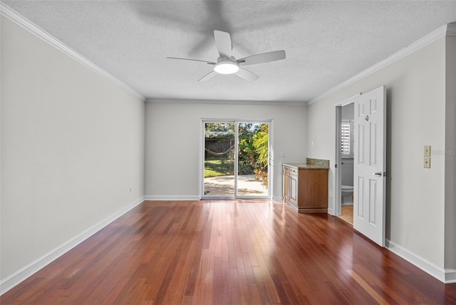 empty room featuring a textured ceiling, ceiling fan, dark hardwood / wood-style flooring, and crown molding