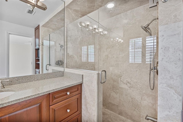 bathroom featuring vanity, a notable chandelier, and walk in shower