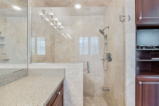 bathroom featuring vanity and a shower with shower door