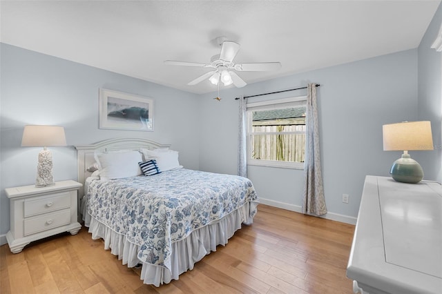 bedroom with light hardwood / wood-style floors and ceiling fan