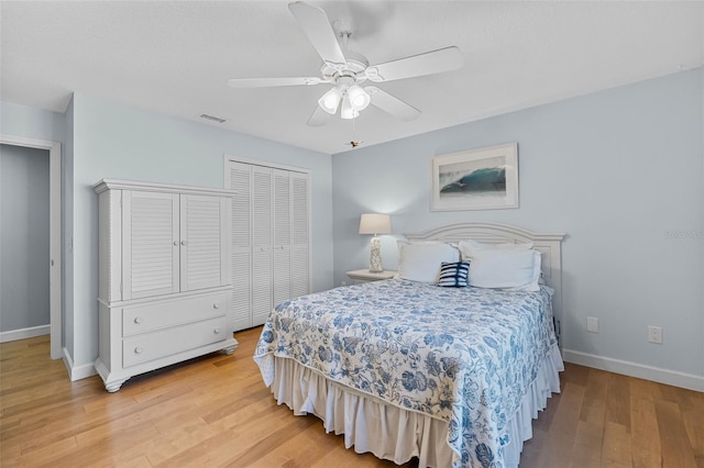 bedroom featuring ceiling fan, a closet, and light hardwood / wood-style flooring