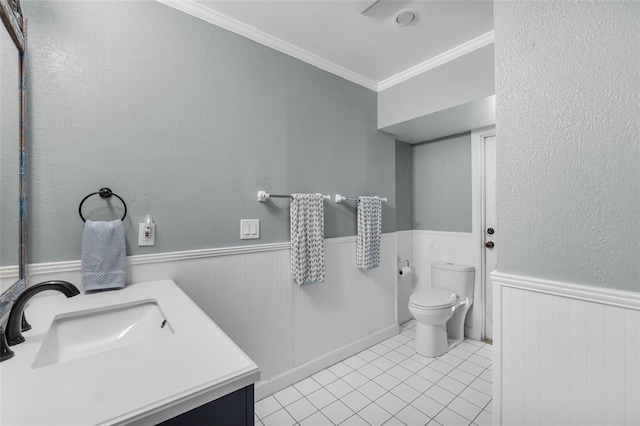 bathroom featuring tile patterned flooring, toilet, vanity, and ornamental molding