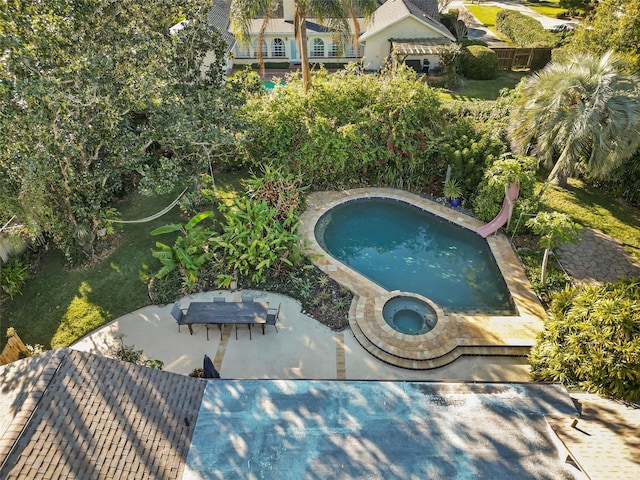 view of pool featuring a patio area, an in ground hot tub, and a water slide