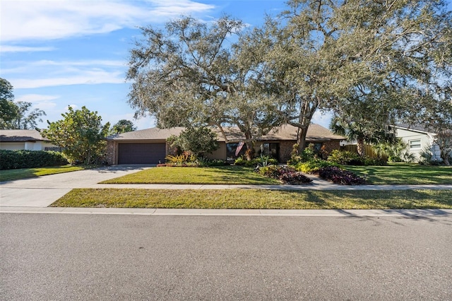 ranch-style home featuring a front lawn and a garage