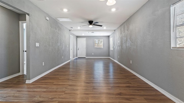 empty room with ceiling fan and dark hardwood / wood-style floors