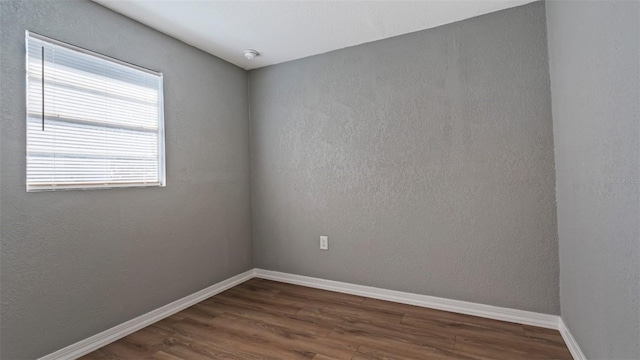 unfurnished room featuring dark hardwood / wood-style flooring