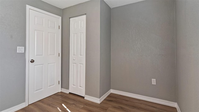 unfurnished bedroom featuring dark hardwood / wood-style floors