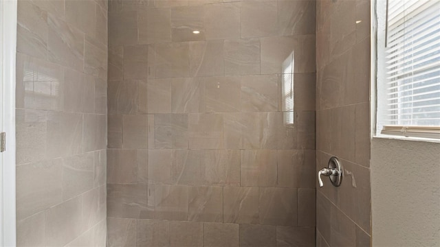 bathroom with a tile shower