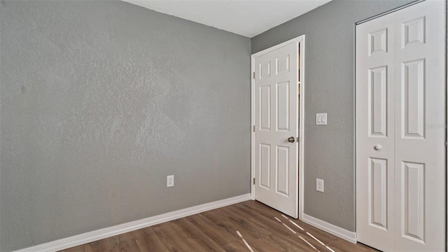 unfurnished bedroom featuring dark wood-type flooring