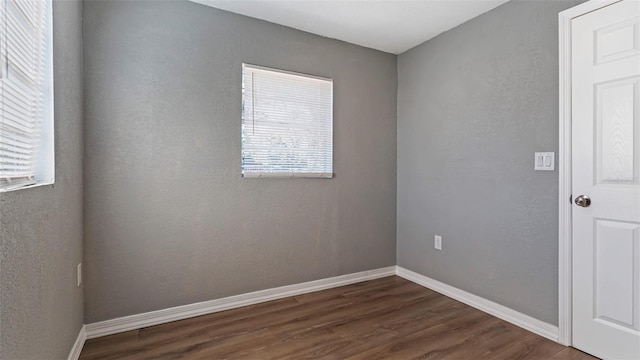 spare room with dark hardwood / wood-style flooring