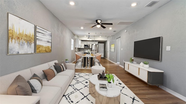 living room with ceiling fan and dark hardwood / wood-style flooring