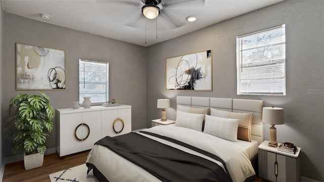 bedroom with ceiling fan and dark hardwood / wood-style flooring