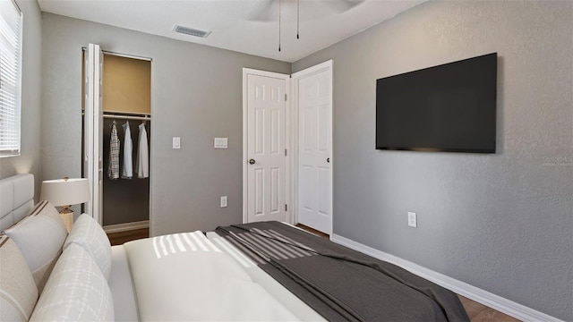 bedroom featuring ceiling fan and a closet