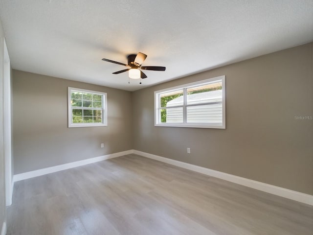 unfurnished room featuring ceiling fan and light hardwood / wood-style floors