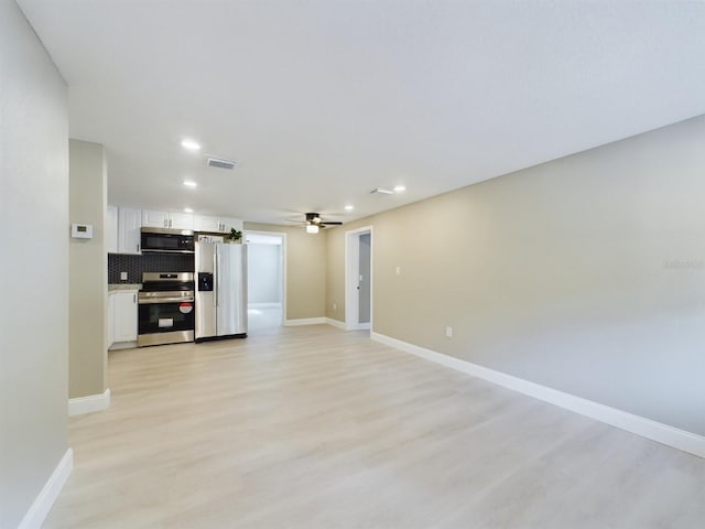 unfurnished living room featuring ceiling fan and light hardwood / wood-style floors