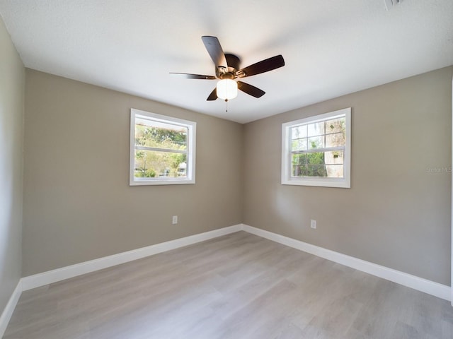 empty room with light hardwood / wood-style floors and ceiling fan