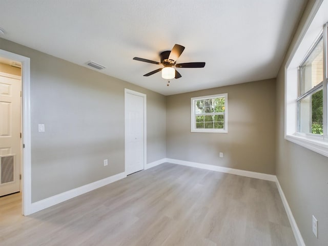 unfurnished room with ceiling fan and light hardwood / wood-style floors