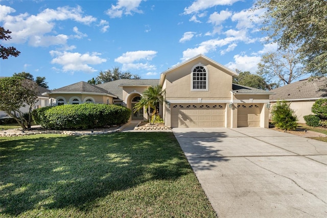 view of front of house featuring a garage and a front lawn