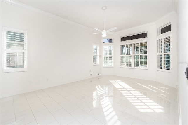 spare room featuring light tile patterned floors, ceiling fan, and crown molding