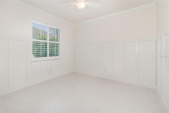 spare room featuring ceiling fan and ornamental molding