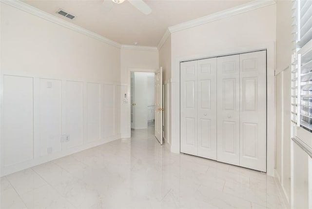 unfurnished bedroom featuring ceiling fan, crown molding, and multiple windows