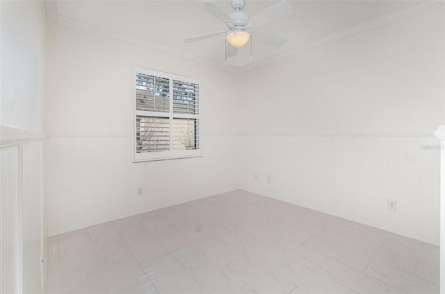 spare room featuring ceiling fan and crown molding