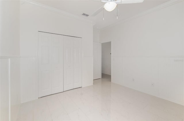 unfurnished bedroom with a closet, ceiling fan, and crown molding