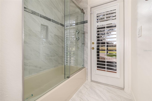 bathroom with combined bath / shower with glass door