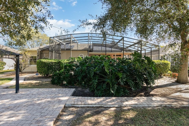 view of property exterior featuring glass enclosure