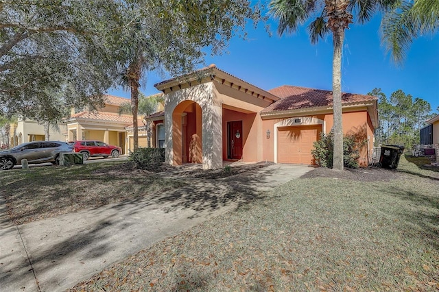 mediterranean / spanish home with a front lawn and a garage