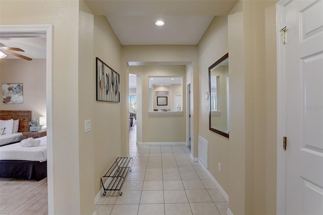 corridor with light tile patterned floors