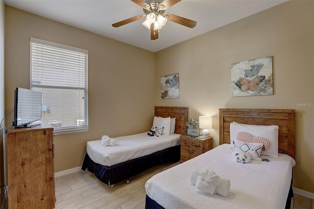 bedroom featuring multiple windows, light wood-type flooring, and ceiling fan