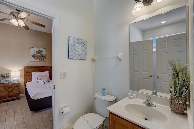 bathroom with ceiling fan, vanity, and toilet