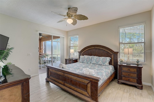 bedroom with ceiling fan, access to exterior, light wood-type flooring, and a textured ceiling