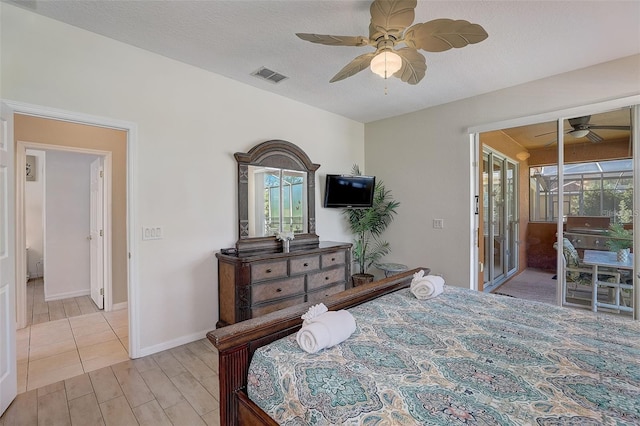 bedroom featuring ceiling fan, access to exterior, and a textured ceiling