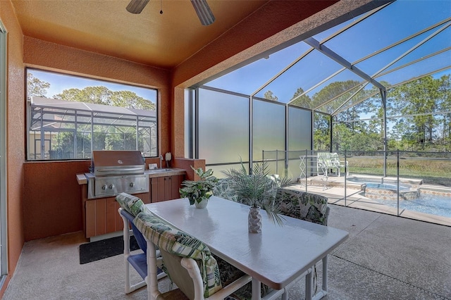 sunroom / solarium featuring ceiling fan