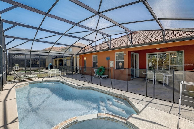 view of pool with a lanai, a patio area, and ceiling fan