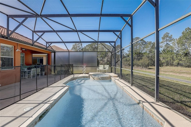 view of swimming pool featuring an in ground hot tub, a patio, and glass enclosure